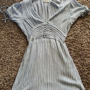 Urban outfitters blue and white striped dress, buttons on rib cage. Small snag.